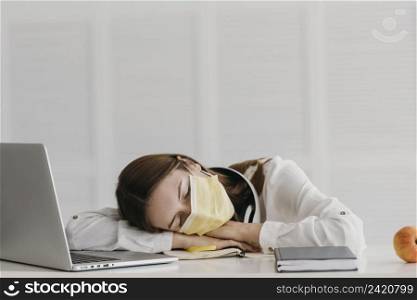 student wearing medical mask sleeping