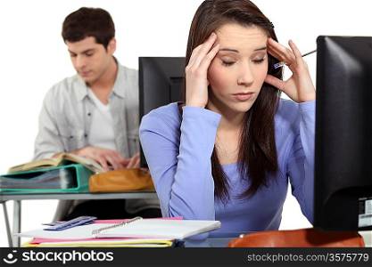 Student with a headache at a computer