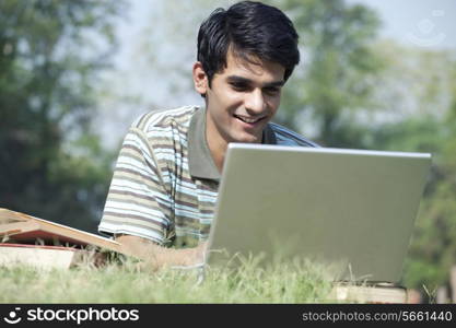 Student with a laptop in a park