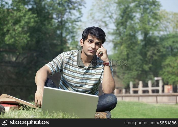 Student with a laptop thinking