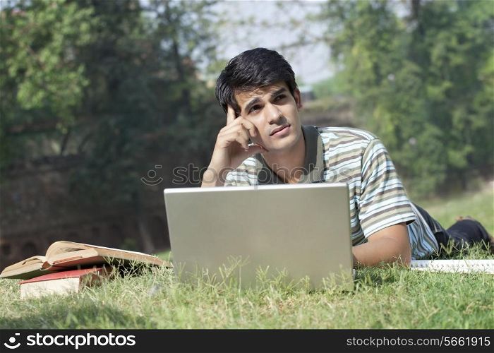 Student with a laptop thinking