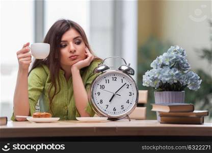 Student with gian alarm clock preparing for exams
