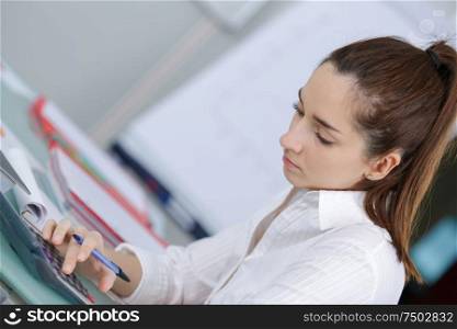 student with notebook and calculator