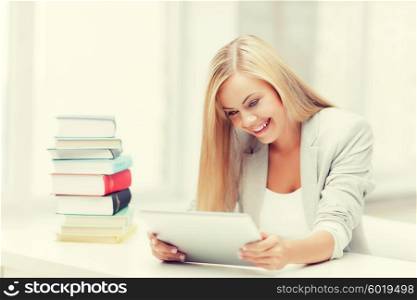 student with tablet pc and stack of books. student with books and tablet pc