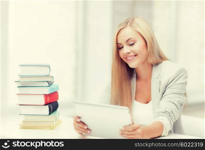 student with tablet pc and stack of books. student with books and tablet pc