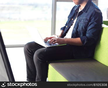 student working on laptop computer at university school modern interior