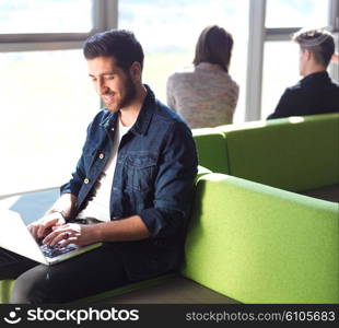 student working on laptop computer at university school modern interior