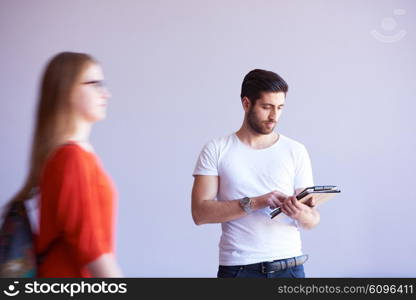 student working on tablet computer at university school modern interior, people group passing by in background and make movement trails