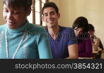 Students and college education, portrait of hispanic man smiling at camera during test at university