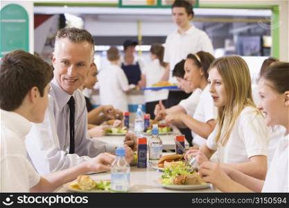 Students and teacher having lunch in dining hall