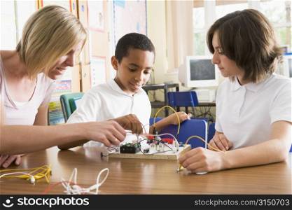 Students and teacher in class with electronic project