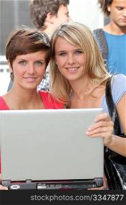 Students at college campus with laptop computer