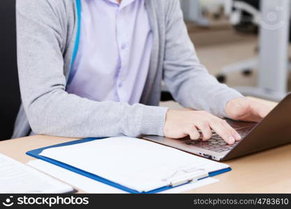 Students at lecture. Close up image of young people using laptop at classroom