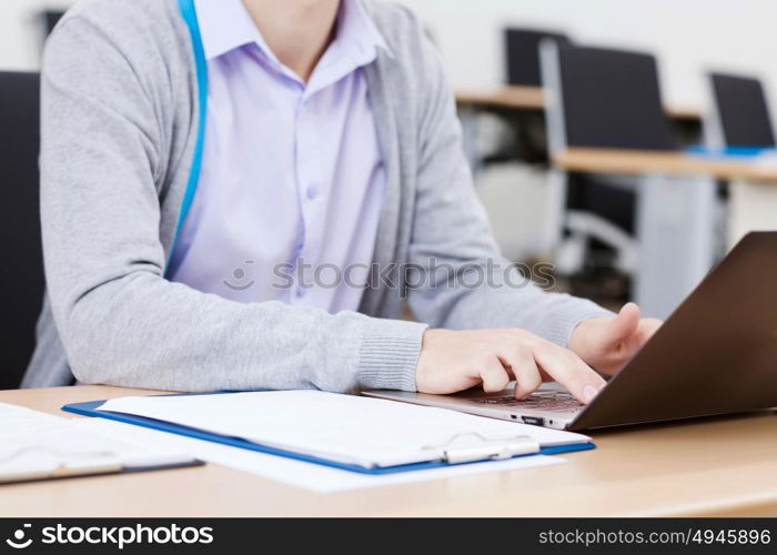 Students at lecture. Close up image of young people using laptop at classroom