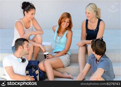 Students enjoying break sitting on school steps happy teenage friends