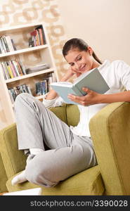 Students - Female teenager reading book in modern living room