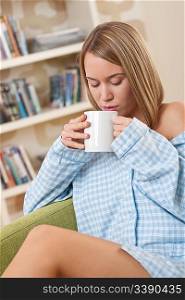 Students - Female teenager wearing pajamas and having cup of coffee