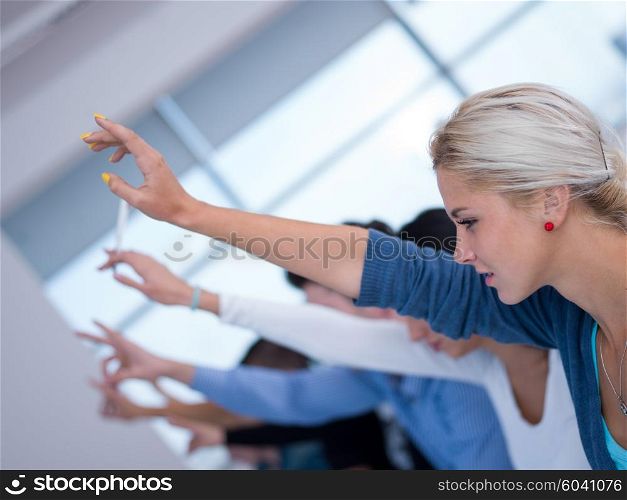 students group raise hands up in classroom
