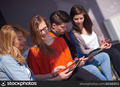 students group working on school project together on tablet computer at modern university