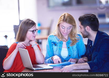 students group working on school project together on tablet computer at modern university