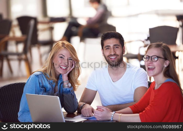 students group working on school project together on tablet computer at modern university