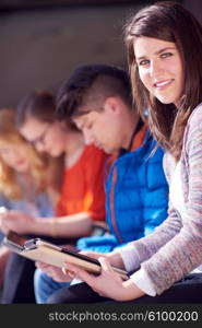 students group working on school project together on tablet computer at modern university