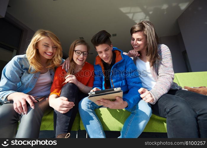 students group working on school project together on tablet computer at modern university