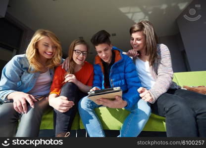 students group working on school project together on tablet computer at modern university