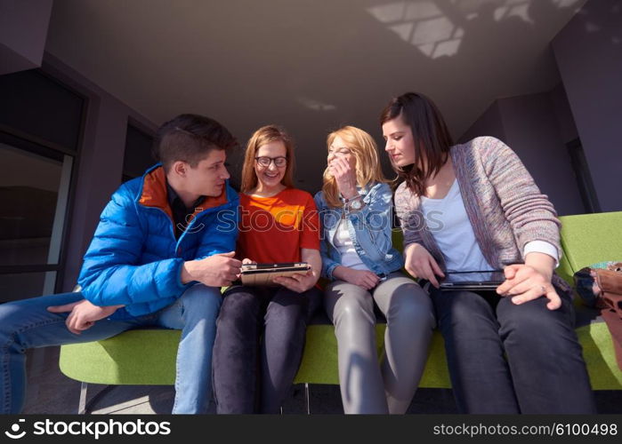 students group working on school project together on tablet computer at modern university