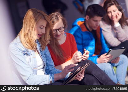 students group working on school project together on tablet computer at modern university