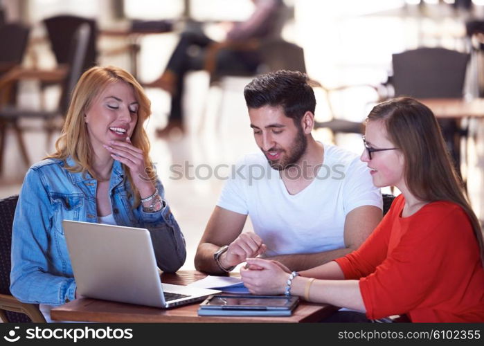 students group working on school project together on tablet computer at modern university