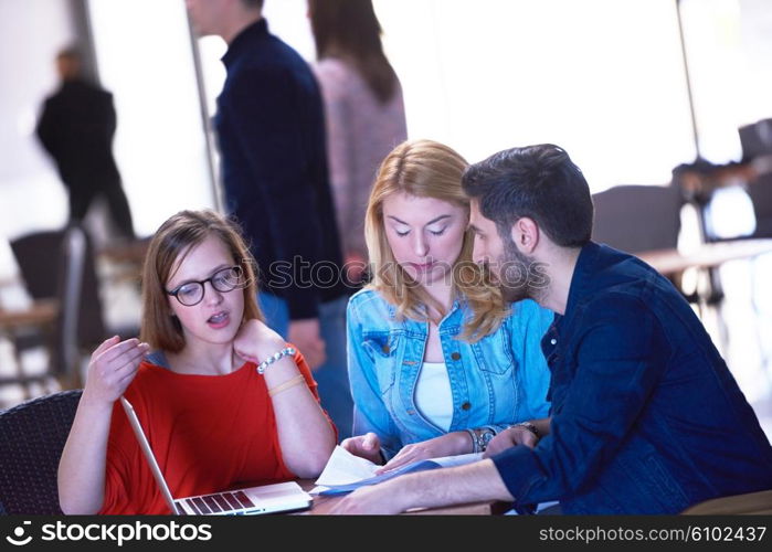 students group working on school project together on tablet computer at modern university