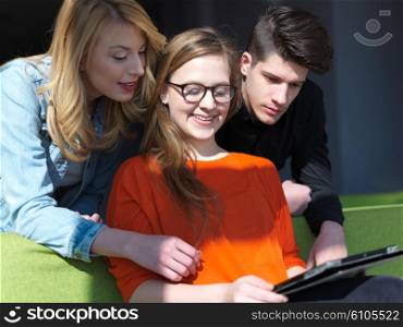 students group working on school project together on tablet computer at modern university