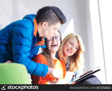 students group working on school project together on tablet computer at modern university