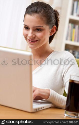 Students - Happy teenager with laptop in modern lounge sitting on armchair