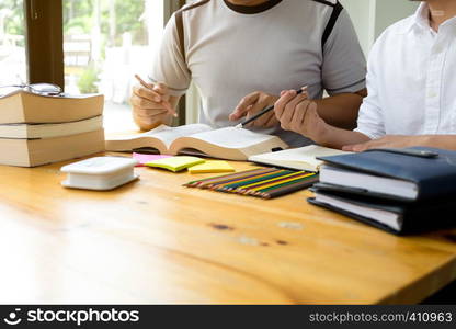 Students helps friend teaching and learning subject additional in library. Education concept.