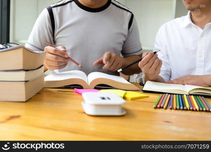 Students helps friend teaching and learning subject additional in library. Education concept.