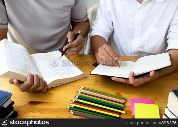 Students helps friend teaching and learning subject additional in library. Education concept.