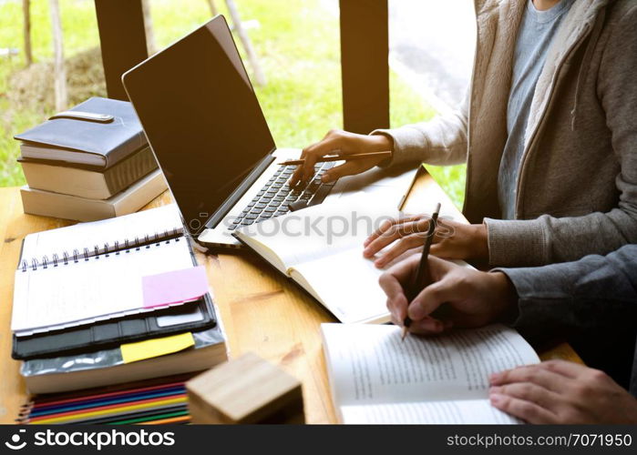 Students helps friend teaching and learning subject additional in library. using laptop to the education . education concept.