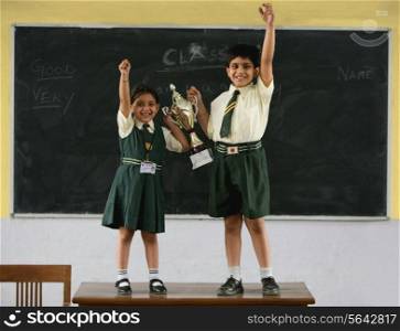 Students holding a trophy