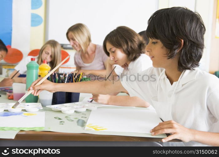 Students in art class with teacher (depth of field)