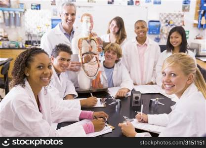Students in biology class with teacher
