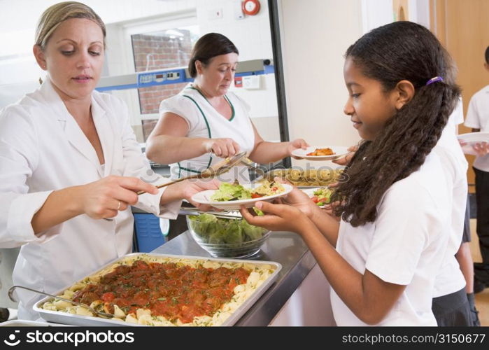 Students in cafeteria line being served lunch