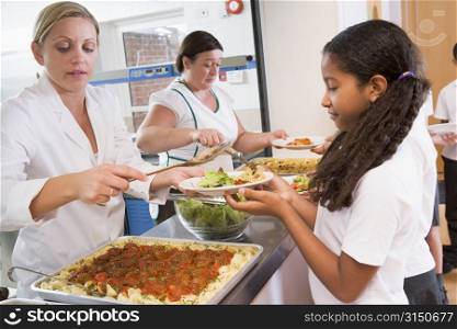 Students in cafeteria line being served lunch