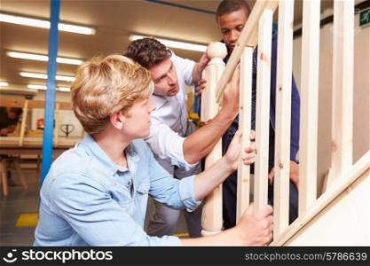 Students In Carpentry Class Working On Staircase