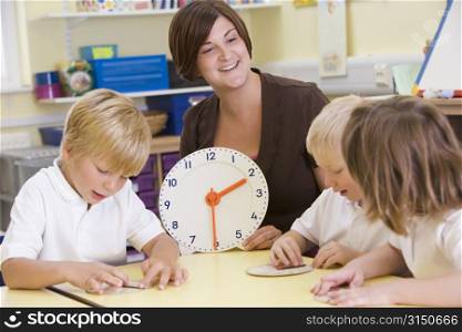 Students in class learning how to tell time (selective focus)