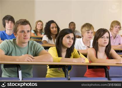 Students in class paying attention and taking notes (depth of field)