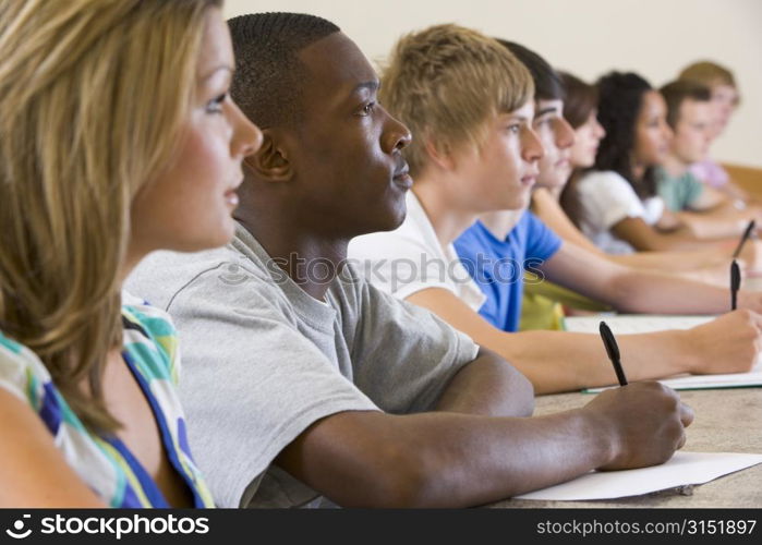 Students in class paying attention and taking notes (selective focus)