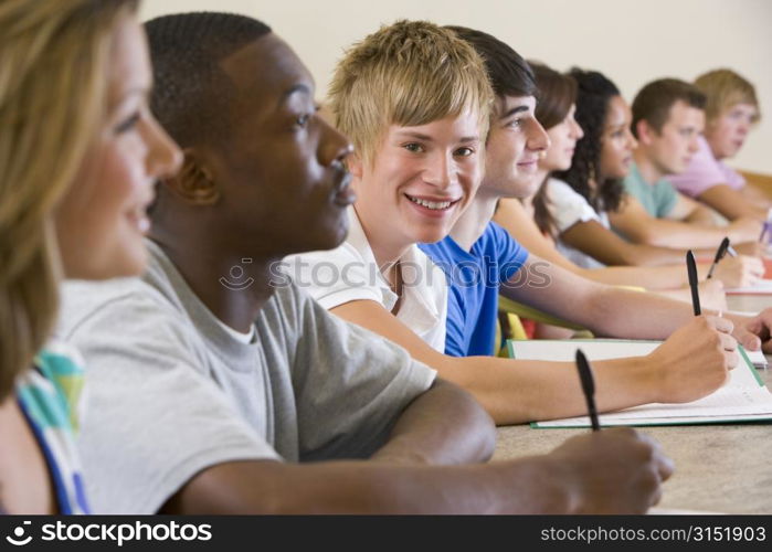 Students in class paying attention and taking notes (selective focus)