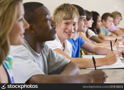 Students in class paying attention and taking notes (selective focus)